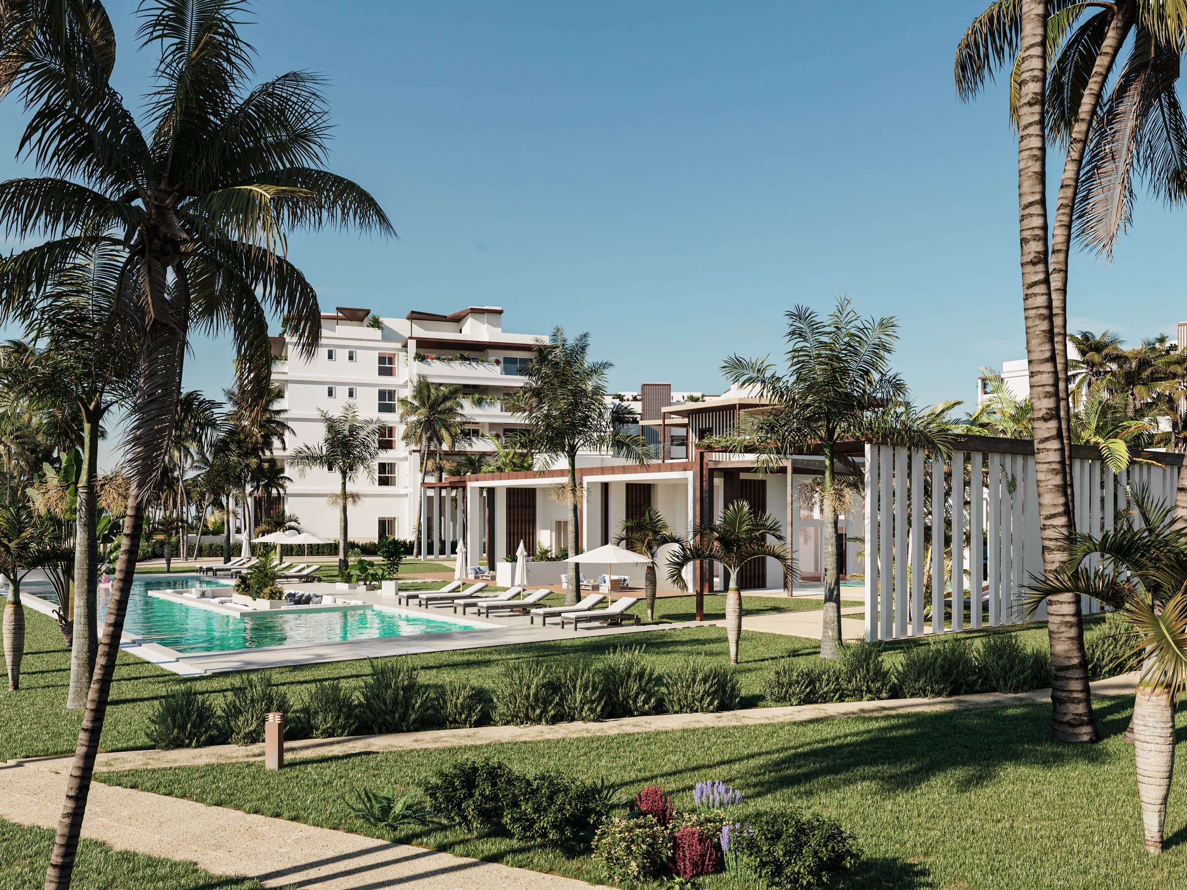 Baycana building framed by palms with the pool in the foreground