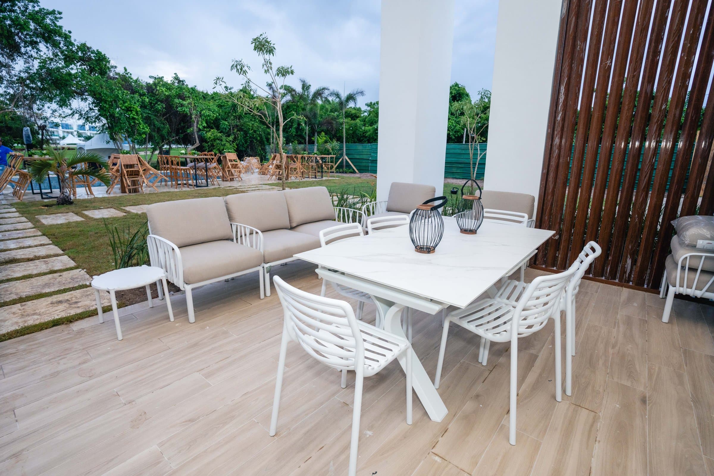 Covered terrace with lounge seating at a Baycana model residence