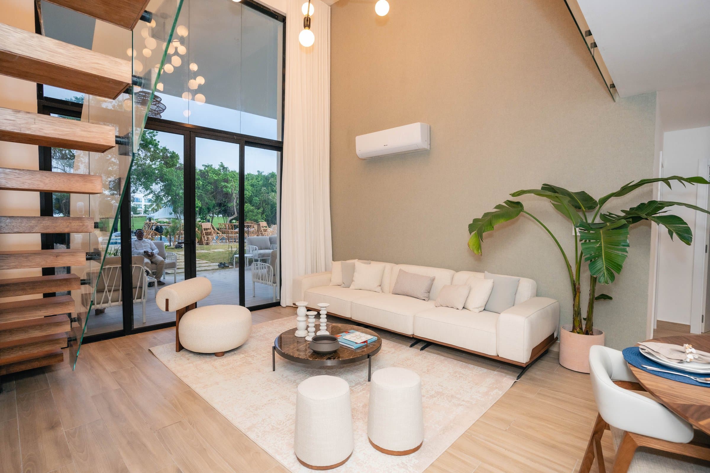 Double-height lounge with cream sectional sofa